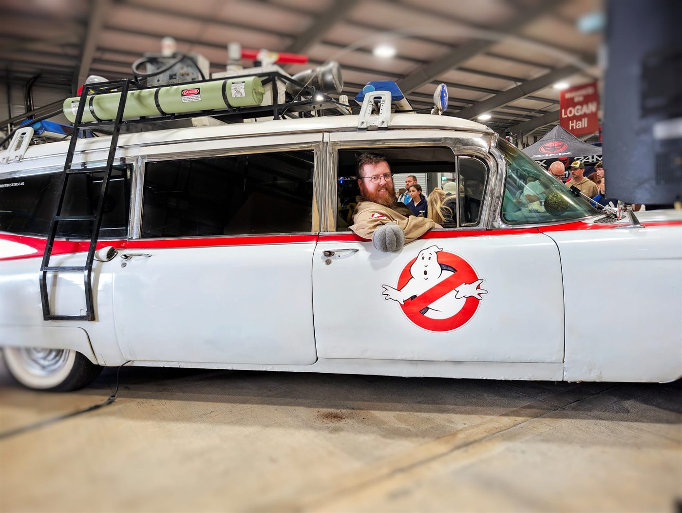 Costumed appearance beside a themed vehicle