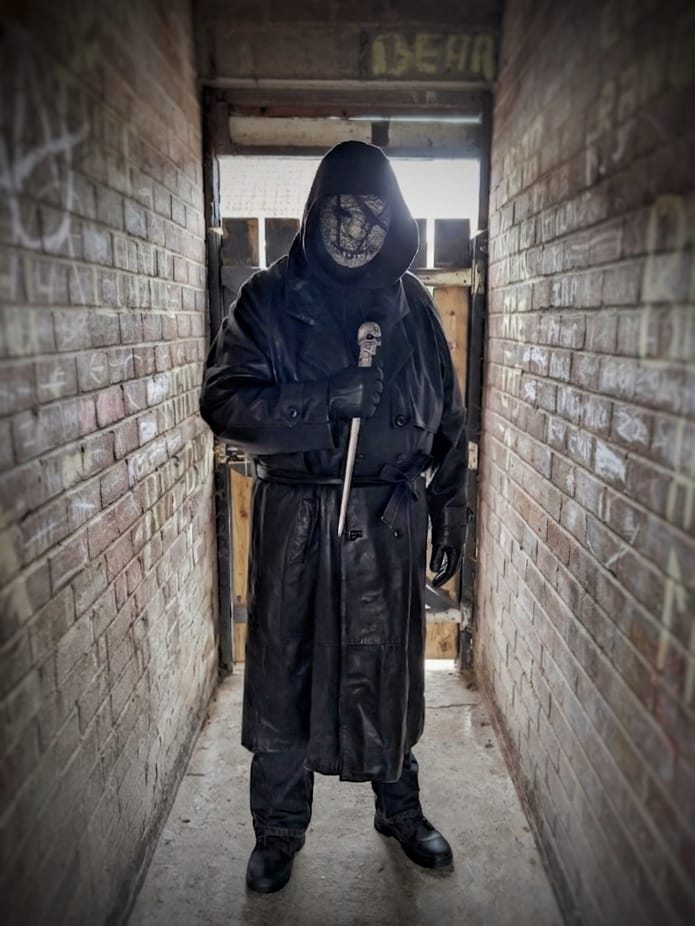 Original masked horror costume in a corridor